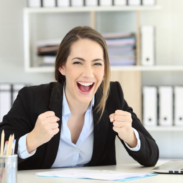 Front view portrait of an excited executive looking at camera at office